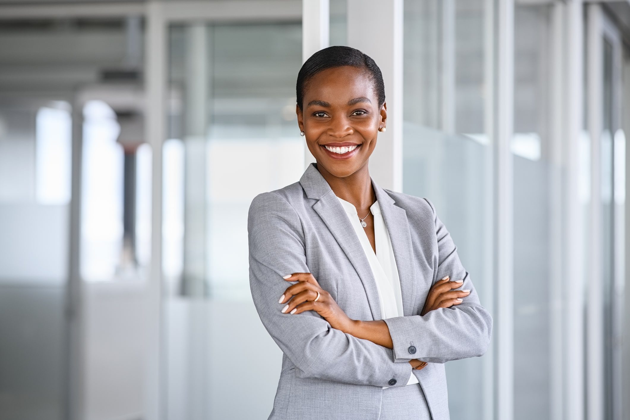 GettyImages-1413765605-min A woman in grey jacket standing with her arms crossed.